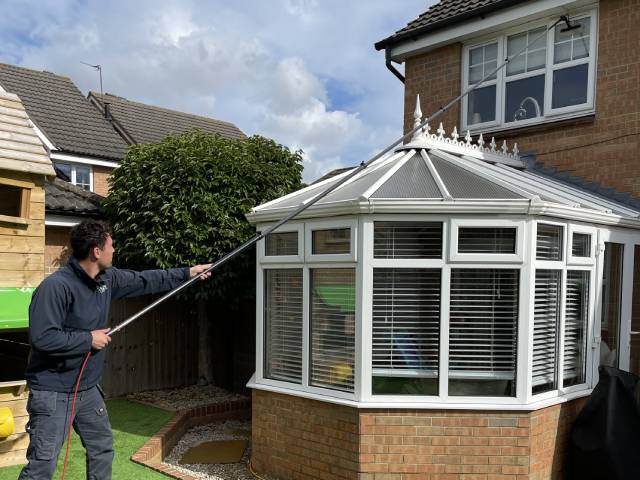 cleaning windows on a house