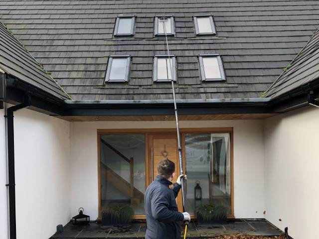cleaning roof windows on a house