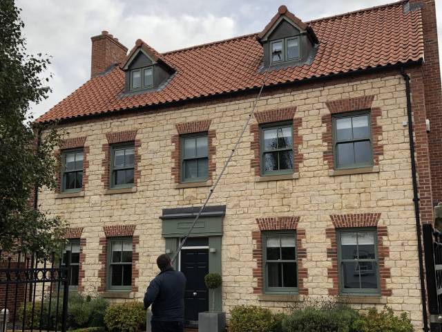 cleaning roof windows on a house